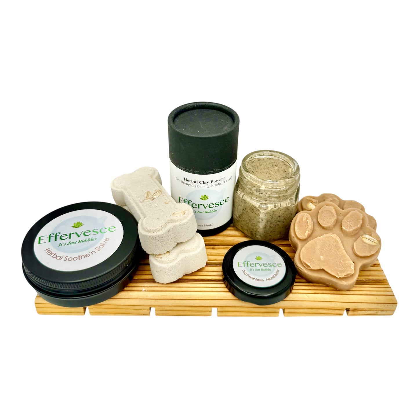 Collection of Effervesce pet care products including jars and a soap on a wooden tray.